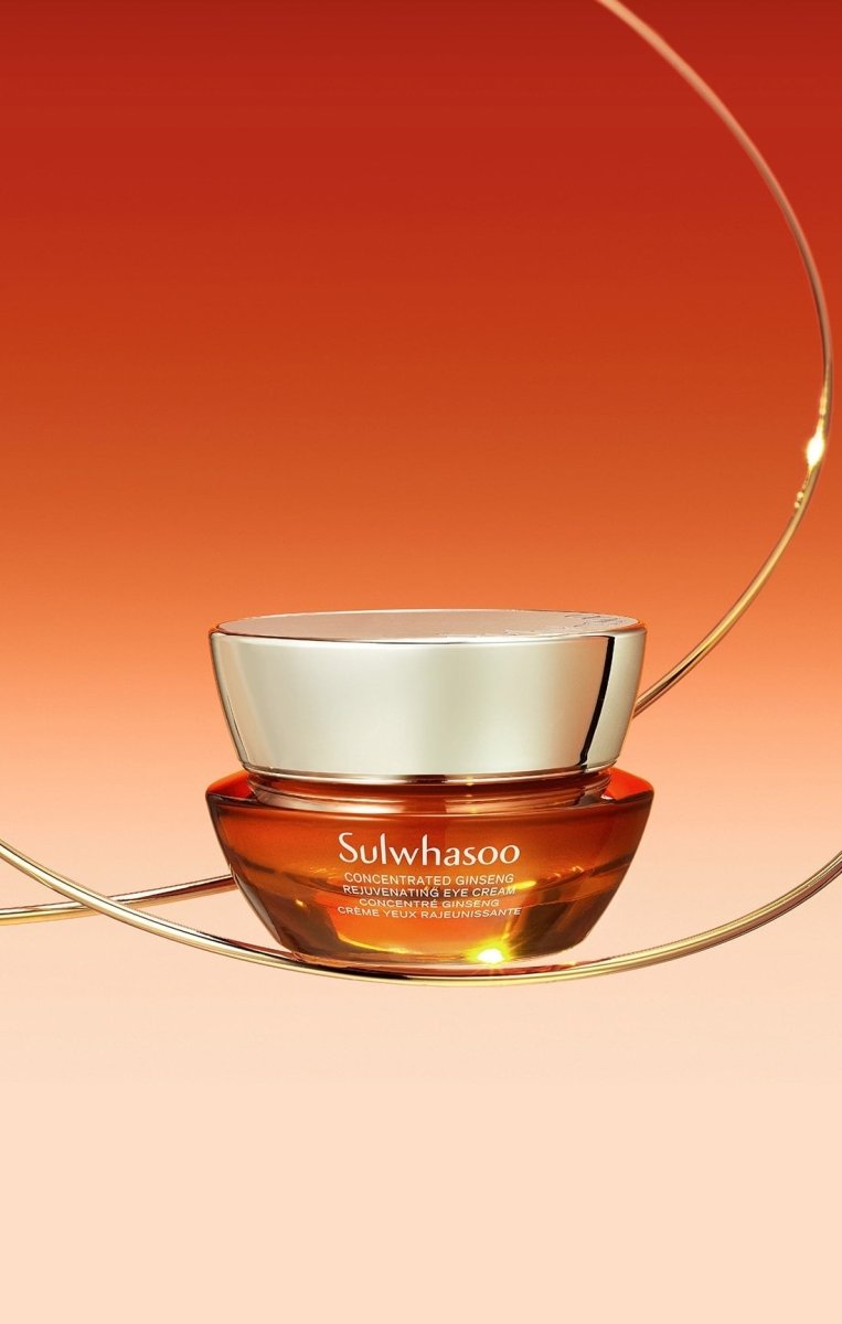 Amber glass jar of concentrated ginseng eye cream with reflective gold lid, set against warm gradient background