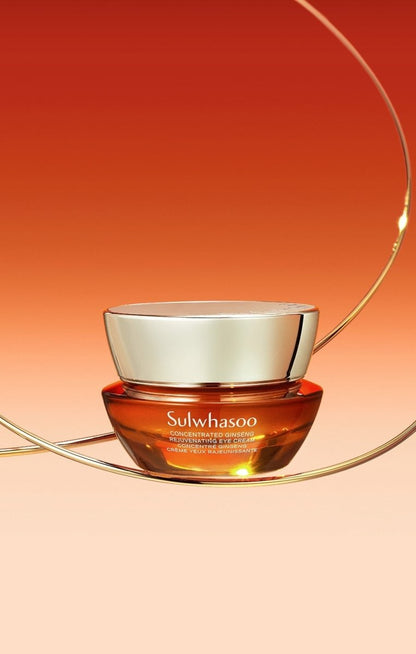 Amber glass jar of concentrated ginseng eye cream with reflective gold lid, set against warm gradient background