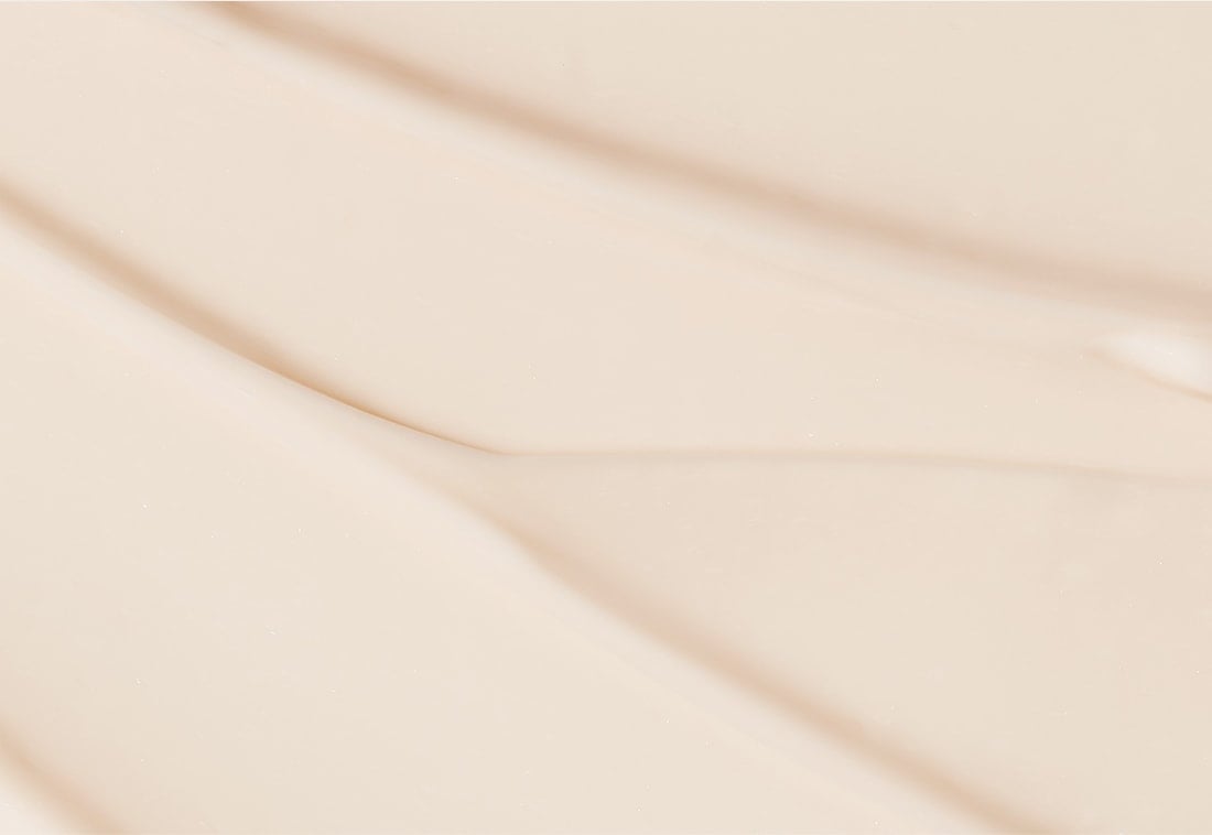 Smooth, light beige texture of hydrating eye cream emphasizing gentle application and skin nourishment benefits