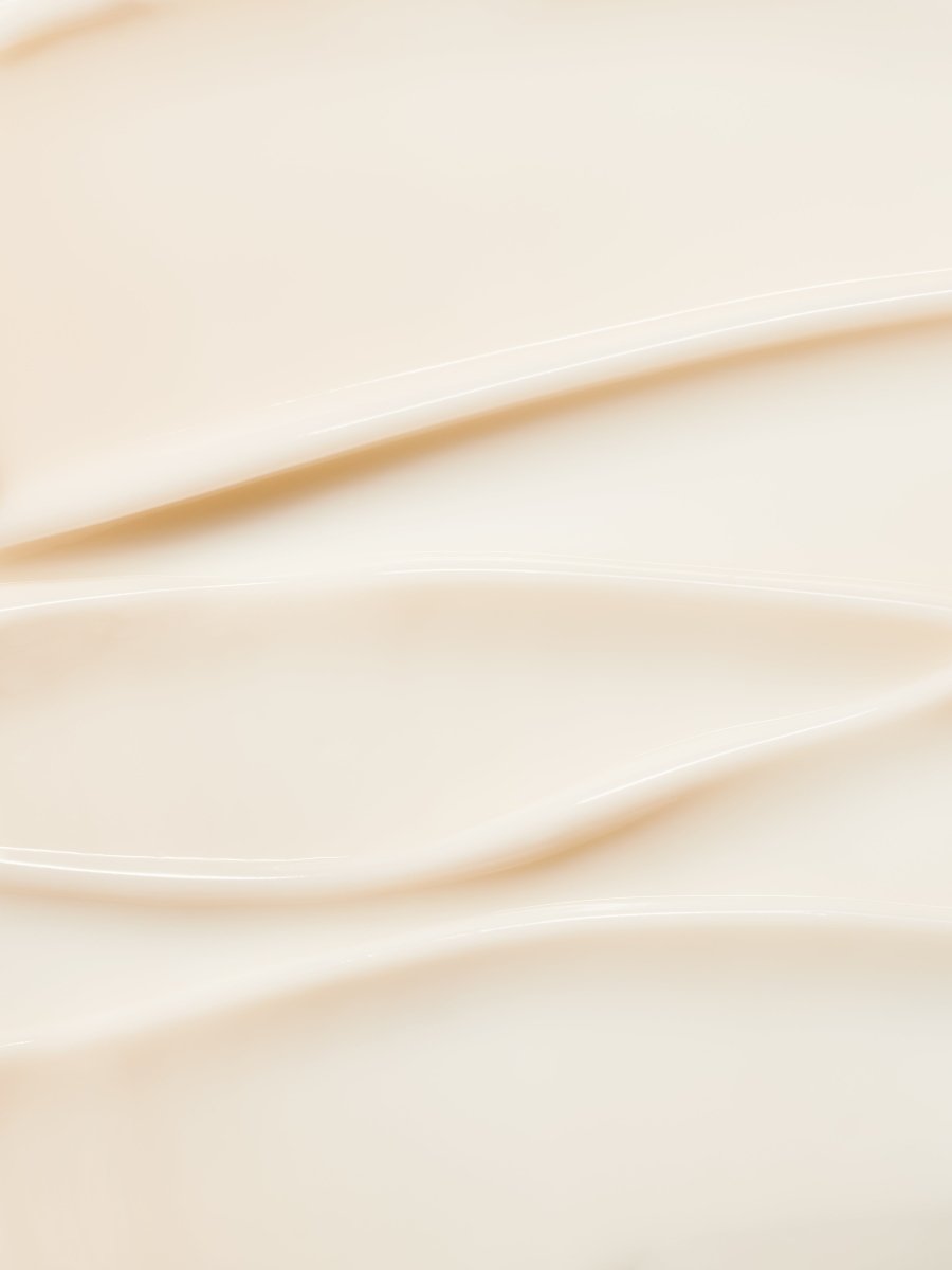 Smooth swirls of creamy texture showcasing hydrating skincare formula with soft beige tones
