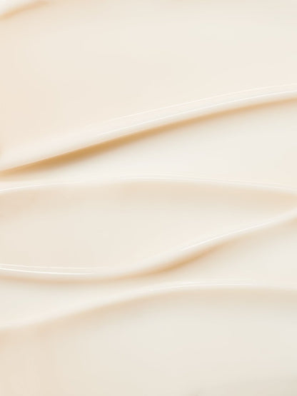 Smooth swirls of creamy texture showcasing hydrating skincare formula with soft beige tones
