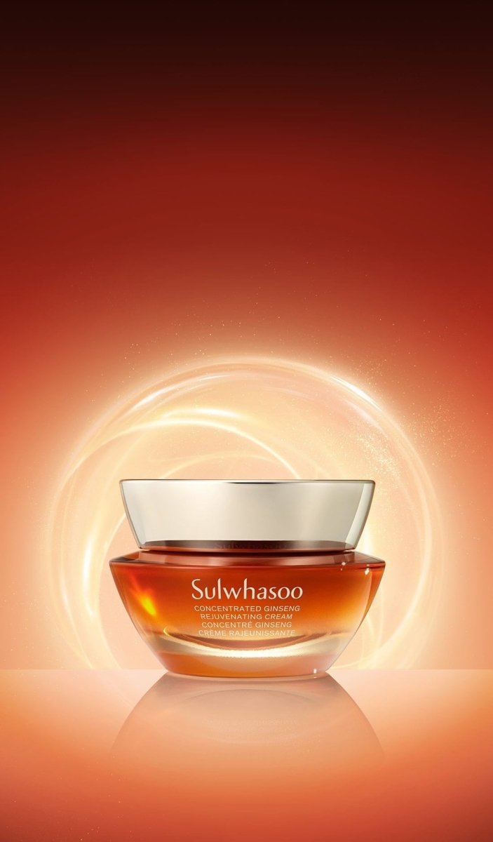 Amber glass jar of renewing cream with silver lid on glowing warm orange background symbolizing hydration boost