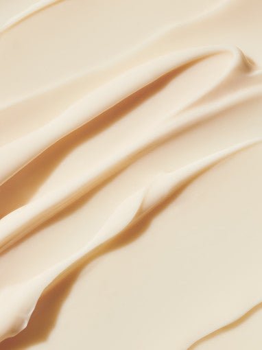 Smooth cream texture in soft beige tone highlighting rich, nourishing anti-aging skincare properties