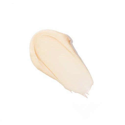 Smooth creamy beige swatch of rich anti-aging cream texture on white background