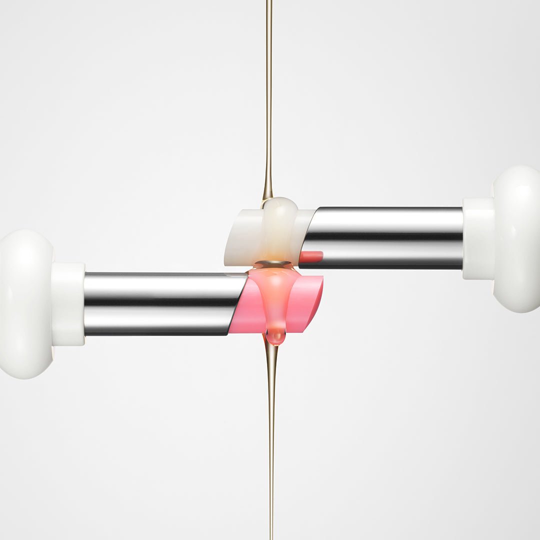 Close-up of two silver lip balm sticks with soft pink glowing balm and clear hydration serum dripping between them on white background