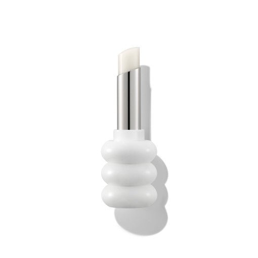 White lip balm stick in a sculpted white holder with a shiny silver twist-up base on a plain background