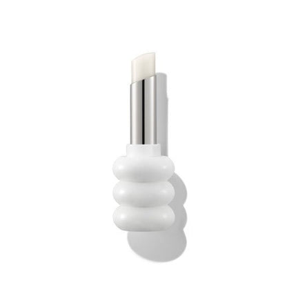 White lip balm stick in a sculpted white holder with a shiny silver twist-up base on a plain background