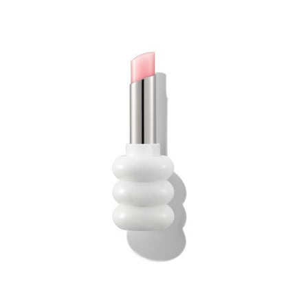 Soft pink tinted lip balm with glossy finish in a modern white sculpted tube packaging on white background