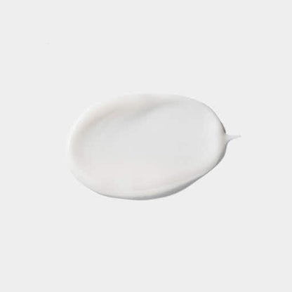 Smooth white emulsion cream texture sample showing lightweight hydration and moisture retention properties on pale background