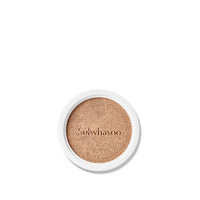 Round cushion refill compact with natural finish foundation embossed with brand name on white background