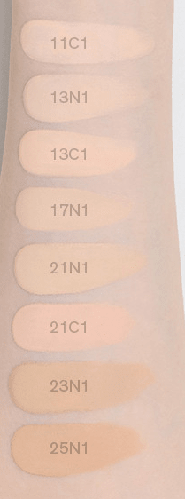 Swatches of cushion foundation shades on skin, showing a range of natural finish tones from light to medium depth.