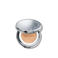 Open silver compact of cushion foundation with natural finish tinted sponge and subtle brand logo on lid