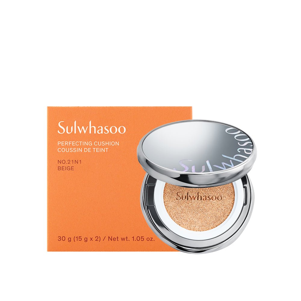 Open silver compact cushion foundation with beige tone alongside matching orange box packaging for natural finish coverage