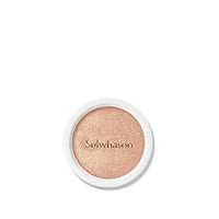 Close-up of a natural finish cushion refill with soft beige tone and brand name embossed on surface in white casing
