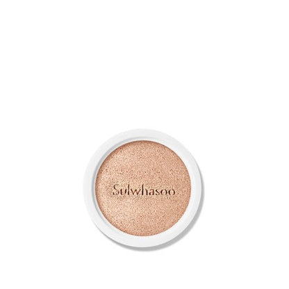 Close-up of a natural finish cushion refill with soft beige tone and brand name embossed on surface in white casing