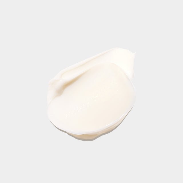 Smooth creamy white swatch of rich texture showcasing elasticity-boosting skincare product cream.