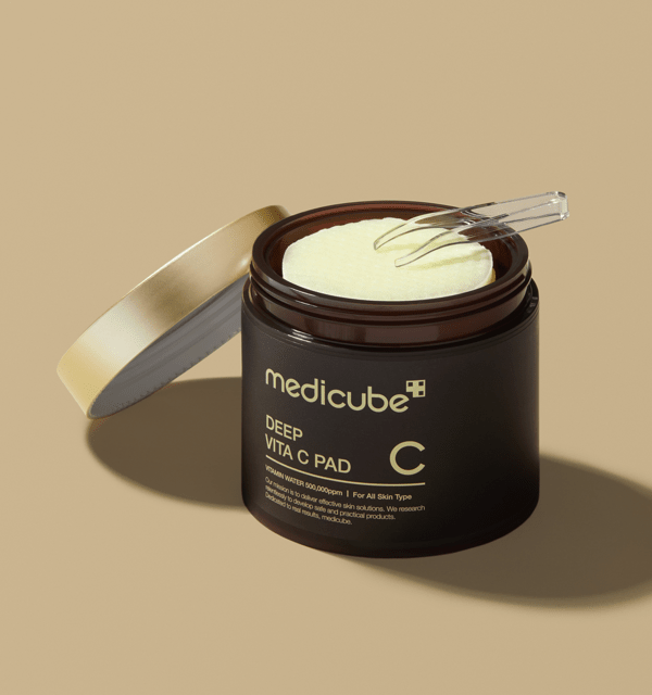 medicube Deep Vita C Pad 150g (70 Pads) jar open showing brightening skincare pads with small applicator fork