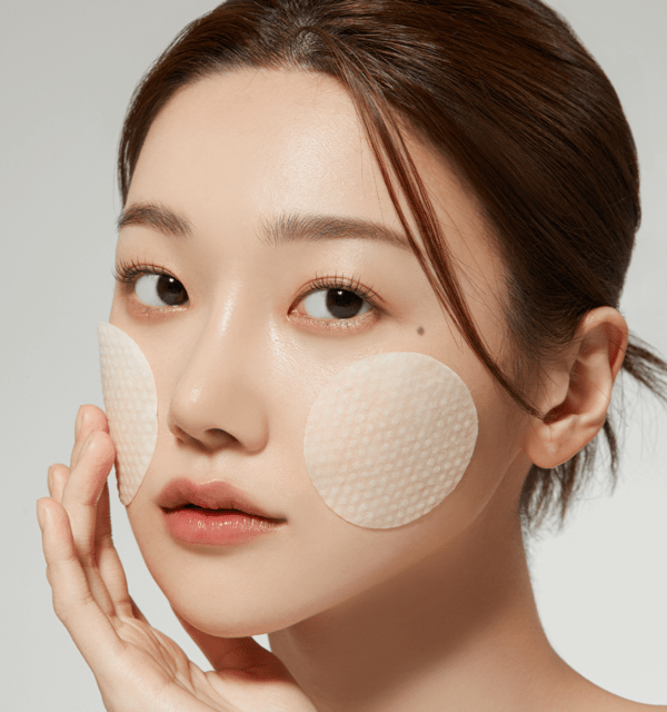 medicube Deep Vita C Pad 150g (70 Pads) applied on cheeks for brightening skincare effect on model's face