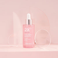 Pink glass dropper bottle of collagen ampoule with silver cap promoting improved skin firmness on soft blush background