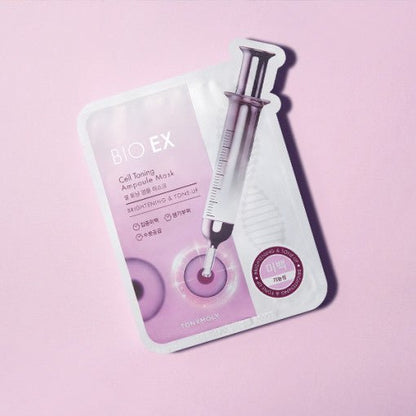 Pink single-use ampoule mask packet featuring a syringe graphic highlighting brightening and tone-up benefits