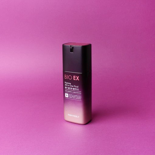 Tall rectangular bottle with gradient pink and black design for age reduction fluid on purple background
