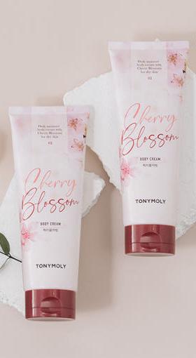 Two soft pink tubes of Cherry Blossom body cream with floral details and deep hydration benefits on light background.