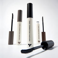 Set of beige and black curl correcting mascaras with curved applicator brushes highlighting clump-free formula benefits