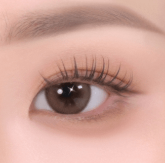 Close-up of eye with soft-textured eyeshadow enhancing natural brown iris and defined lashes with subtle shimmer effect