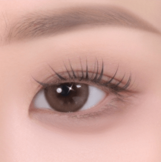 Close-up of an eye with soft-textured eyeshadow and natural-looking lashes emphasizing a smooth, radiant finish