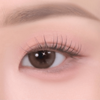 Close-up of eye with soft, natural eyeshadow and long, delicate lashes emphasizing smooth texture effect