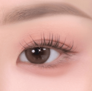 Close-up of eye with soft-textured natural pink eyeshadow enhancing delicate eyelid and lashes look