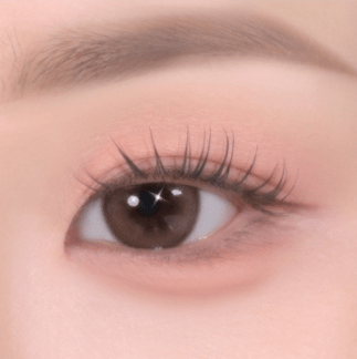 Close-up of eye with soft matte pink eyeshadow and natural eyelashes highlighting smooth texture finish