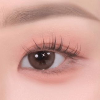 Close-up of eye with soft textured neutral eye shadow enhancing natural eyelash length and gentle tone
