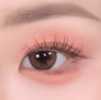Close-up of an eye with soft pink eyeshadow and natural, long eyelashes highlighting delicate texture effects