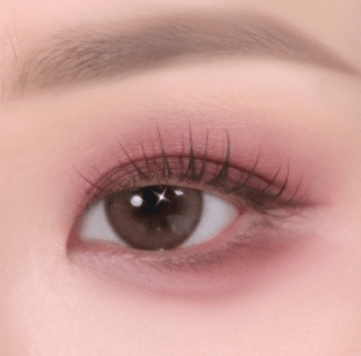 Close-up of eye with soft pink-toned eyeshadow featuring smooth texture and natural, enhanced lash definition