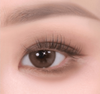 Close-up of eye with soft-textured, natural beige eye shadow creating a smooth, subtle enhancement on the eyelid