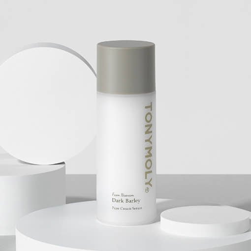Minimalist white serum bottle with gray cap featuring subtle text emphasizing wrinkle reduction benefits