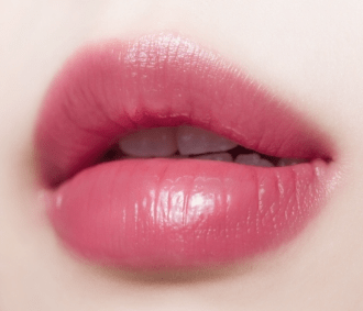 Close-up of lips wearing glossy, natural-looking tint with smooth texture enhancing moisture retention effect