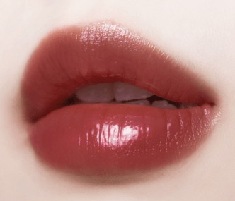 Close-up of lips with glossy, natural-toned tint highlighting smooth, hydrated finish and moisture retention benefits