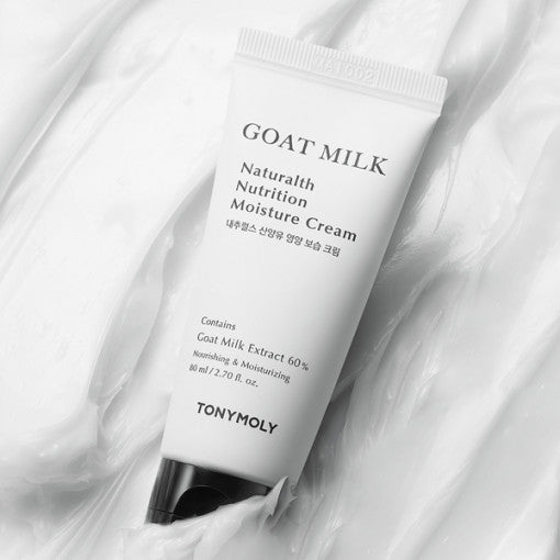 White squeeze tube of moisturizing cream with black cap on smooth creamy white texture background