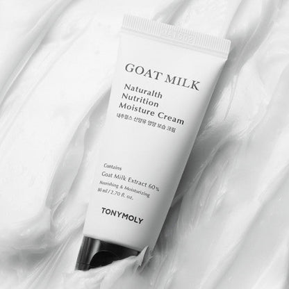 White squeeze tube of moisturizing cream with black cap on smooth creamy white texture background