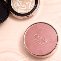 Compact cushion foundation with swirling beige and white tone and pink embossed cover labeled for high-coverage balm
