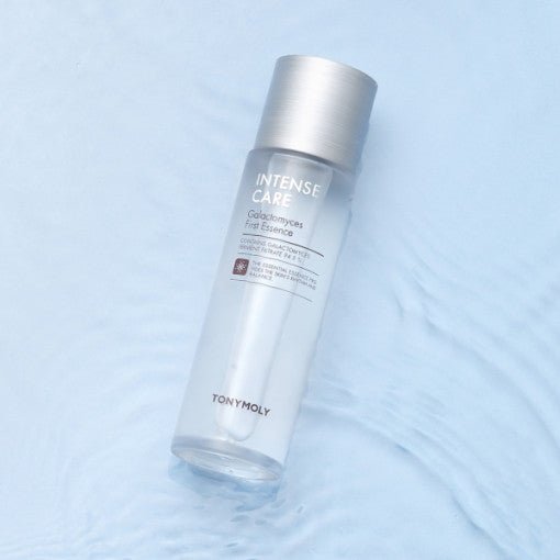 Clear skincare essence bottle with silver cap on rippled light blue surface highlighting enhanced elasticity benefits