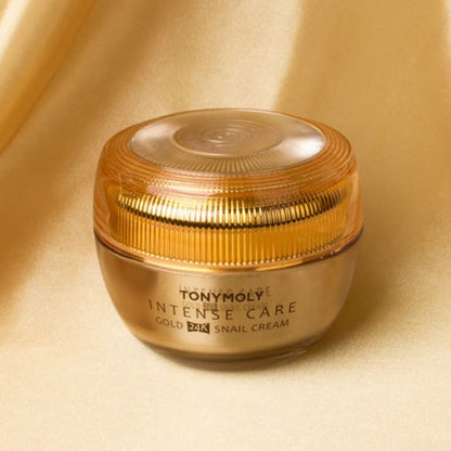 Gold-toned jar of moisturizing snail cream highlighting deep hydration and radiant skin benefits on soft gold fabric background