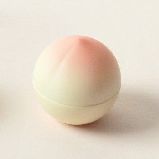 Round peach-shaped container with soft gradient colors representing deep hydration hand cream product