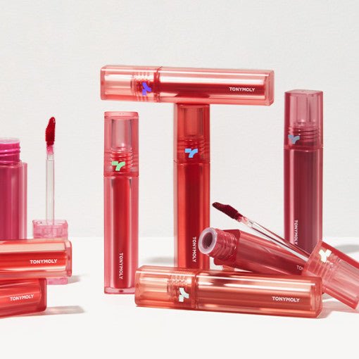 Collection of red and pink lip tint tubes with applicators showcasing rich, long-lasting color shades on white surface