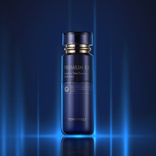 Dark blue bottle of brightening essence featuring gold accents and premium minimalist design on glowing blue background