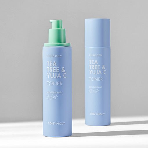 Two pale blue toner bottles with white text and one featuring a green pump dispenser on a neutral background