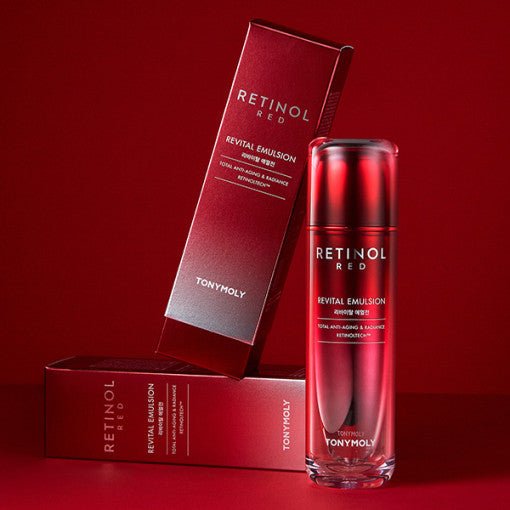 Glass bottle of red retinol revital emulsion with matching red packaging against deep red background