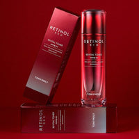 Red gradient bottle of revitalizing toner with matching box on deep red background highlighting wrinkle reduction benefits
